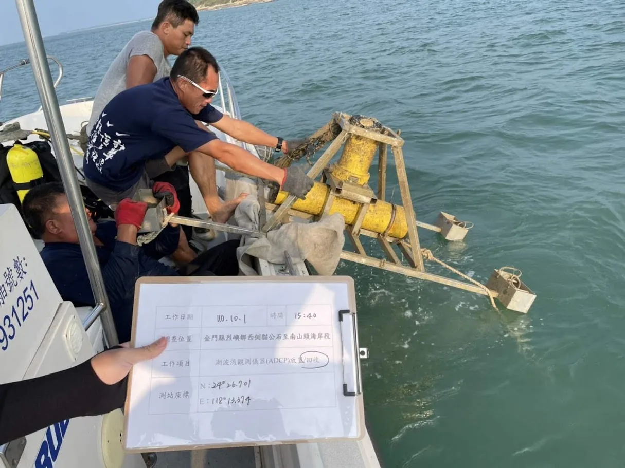 Team lowering an instrument frame from a boat