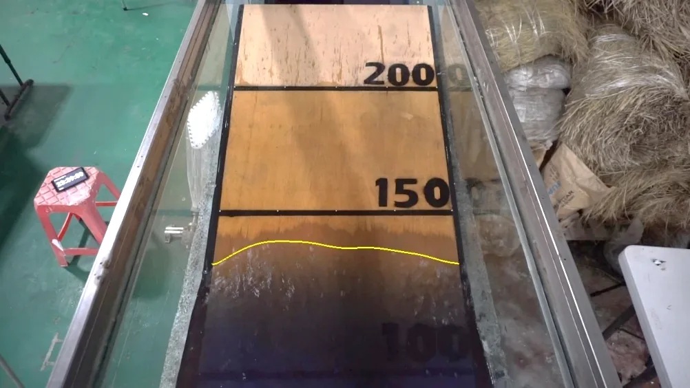 Camera view of a sloping beach in a flume with the detected run-up line